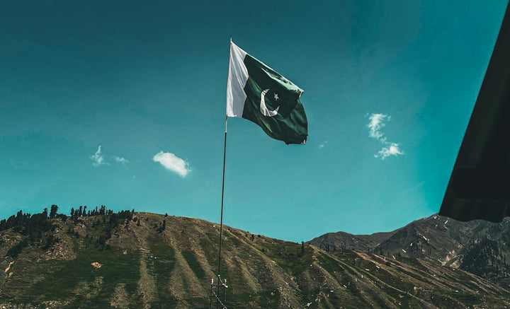 a flag flying on top of a mountain — illustrative stock photo