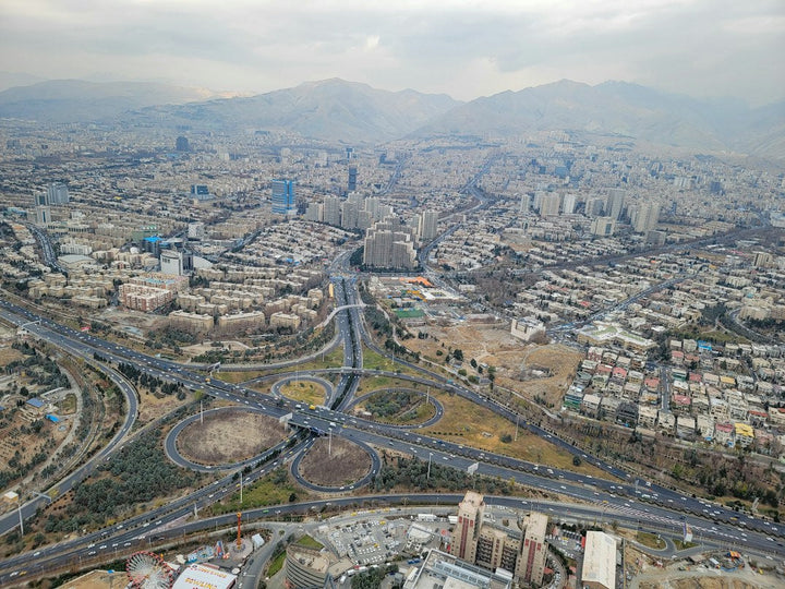 Aerial view of Tehran, Iran, with roads and mountains — illustrative stock photo